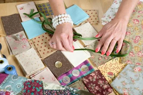 Close up of woman's hand sewing patchwork Stock Photos