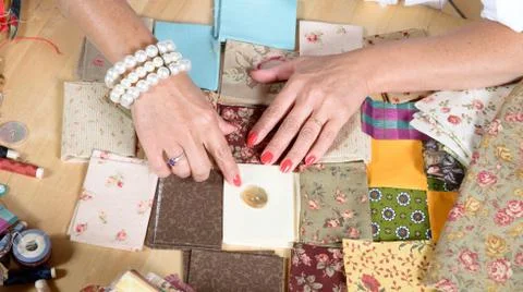 Close up of woman's hand sewing patchwork Stock Photos