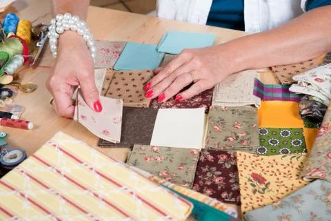 Close up of woman's hand sewing patchwork Stock Photos