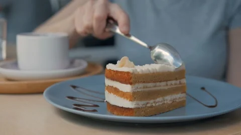 Close-up of a woman's hand with a spoon eating a cake in a cafe. Stock Footage 131381953