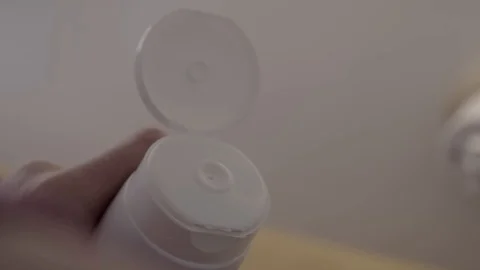 Close up of Woman's Hand Squeezing Face Moisturising cream. 스톡 동영상 112472802