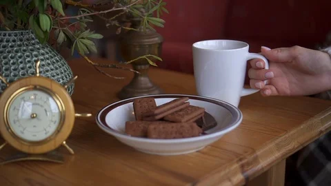 Close-up of woman's hand taking cup of tea from table Stock Footage 119666608