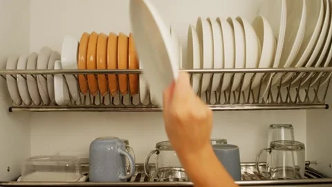 Close-up of a woman's hand taking a plate in the kitchen. Stock Footage 282273679