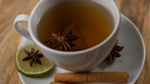 Close-Up of a Woman's Hand Throwing a slice of Lime into a Natural Flavored Tea  Video stock 124685767