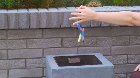 Close-up woman's hand throws used batteries into trash can Stock-Footage 116708623