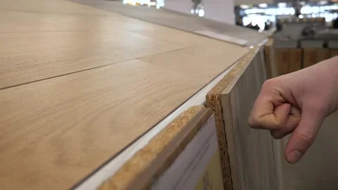 Close-up of a womans hand touching a display sample of tiles in a store Stock Footage 314258145