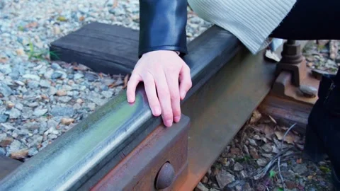 Close-up of a woman's hand touching the rails of a railway. Stock Footage 275571766