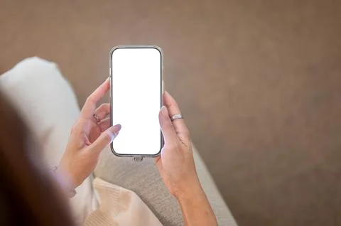 Close up of a woman's hand touching white screen smartphone looking or read.. Stock Photos