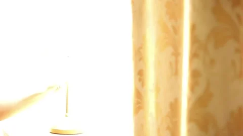 Close-Up Of A Woman's Hand Turning On A Table Lamp Stock Footage 313504193