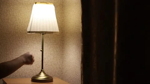 Close-Up Of A Woman's Hand Turning  Off A Table Lamp Stock Footage 313504231
