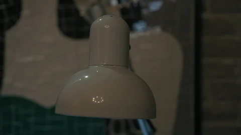Close up woman's hand turns a lamp in camera in beauty salon. Lighting equipment Stock Footage 93989448