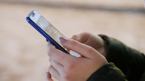 Close-up of a woman's hand uses the mobile app, Christmas and New Year Stock Footage 100464101