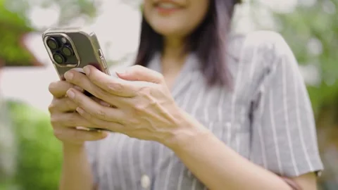 Close-up of a woman's hand using a cell phone to send a message to friends. Stock Footage 252426104