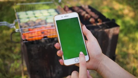 Close up of a woman's hand using a phone with vertical green screen on the Stock Footage 94233598