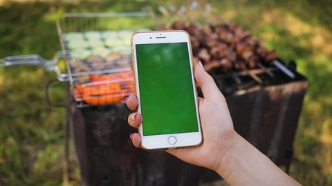 Close up of a woman's hand using a phone with vertical green screen on the Stock Footage 94235012
