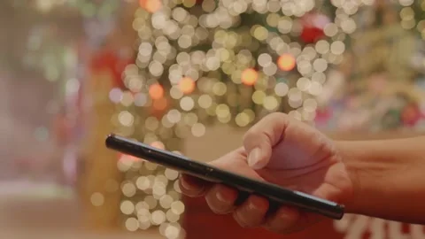A close-up of a woman's hand is using a smartphone with a blurred background. Stock Footage 153853220