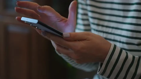 Close-up woman's hand is using smartphone in the living room at home. Stock Footage 220096585