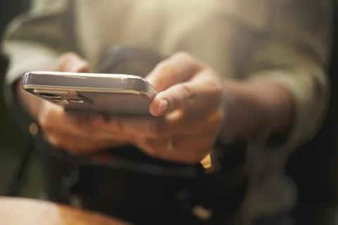 Close-up of woman's hand using a smartphone during coffee break. Foto stock