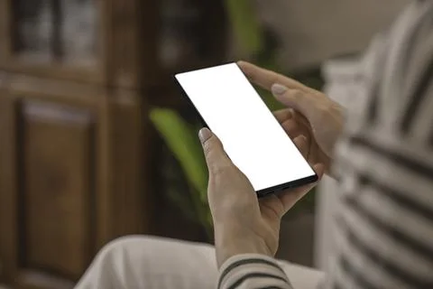 Close-up woman's hand is using smartphone in the living room at home. Foto stock