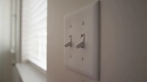 Close up of a woman's hand using a wet wipe to clean off light switches Stock Footage 128920719