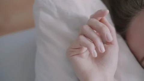 Close up of a woman's hand while she sleeps in bed Stock Footage 131063460