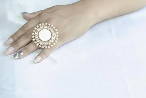 A close-up of a woman's hand on white background with a ring with big nails. Foto stock