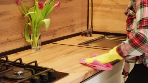 Close-up of a woman's hand wiping a kitchen table while cleaning the kitchen. Stock Footage 265094939