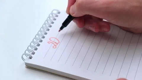 Close-up of woman's hand writes the numbers 2023 and goals for the coming year. Stock Footage 197376103