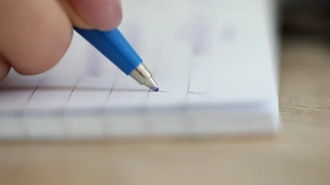 Close-up of a woman's hand writing a checkmark. Stock Footage 244447844