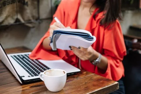 Close up of woman's hand writing in notebook Stock Photos