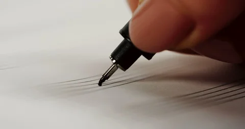 Close up of the woman's hand writing notes with a pen in the musical notebook Stock Footage 86437016