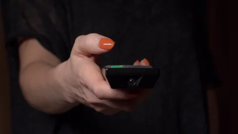 Close up of a woman's hand zapping the remote control Stock Footage 125530479