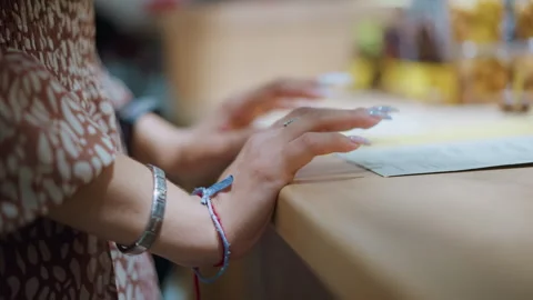 Close-Up of Woman's Hands Adorned with Bracelet and Polished Nails Touching Stock Footage 292829444