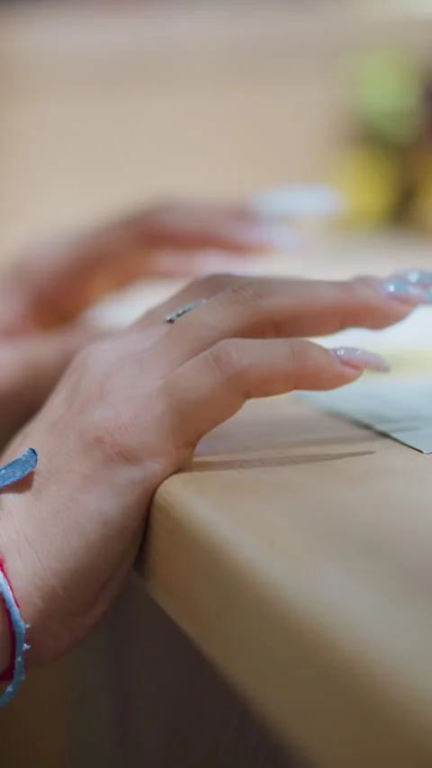 Close-Up of Woman's Hands Adorned with Bracelet and Polished Nails Touching Stock Footage 310705922