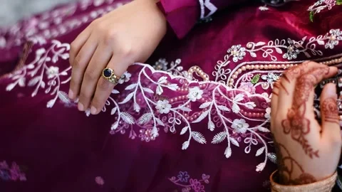 Close-up of a woman's hands adorned with intricate mehndi, gold bangles, an.. Stock Footage 341354139