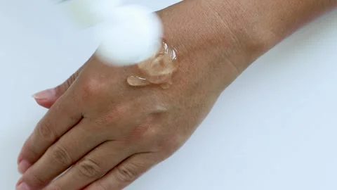 Close-up of Woman's Hands Applying Hand Cream, Skin Care on a Light Background Stock Footage 247456781