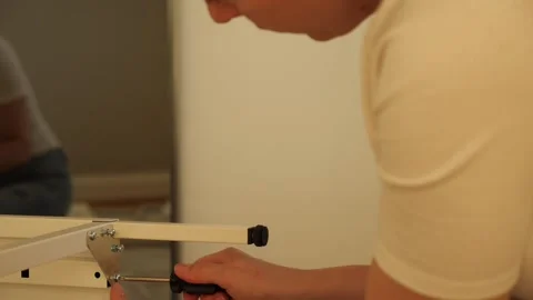 Close up of woman’s hands assembling flat pack furniture with screwdriver Stock Footage 319405484