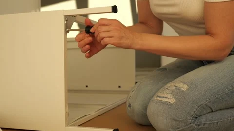 Close up of woman’s hands assembling flat pack furniture with screwdriver Stock Footage 319405712