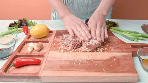 Close-up of woman's hands Coating raw tuna in sesame seeds in 4K. Stock Footage 141302955