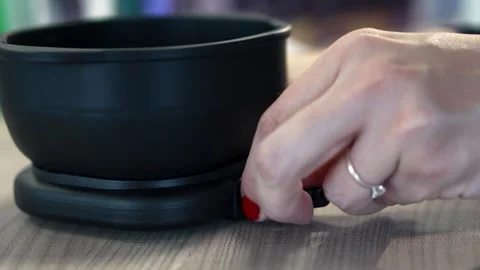 Close up of a womans hands connecting a wire with a switch to a wax heater Stock Footage 312553211