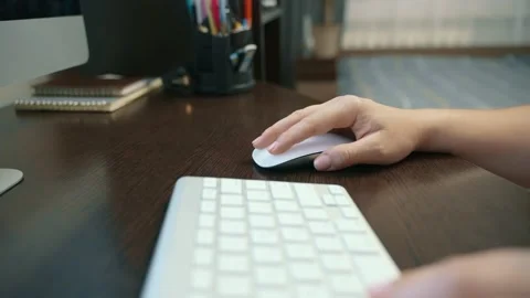 Close-up of a woman's hands controlling a computer mouse while working at home. Stock Footage 217394583