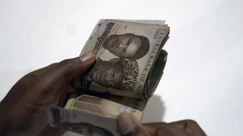 Close up of woman's hands counting Nigerian Naira Notes in slow motion Stock Footage 117370180