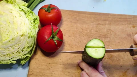 Close up. Woman's hands cuts a cucumber. Slow motion Stock Footage 152793377