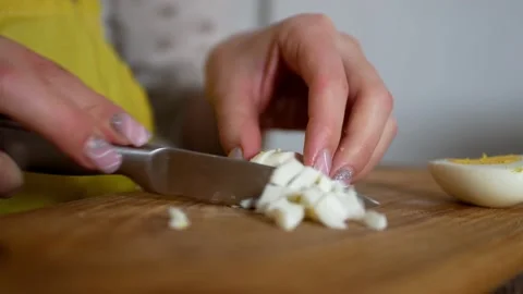 Close up of woman's hands cutting boiled chicken egg Stock Footage 168541877