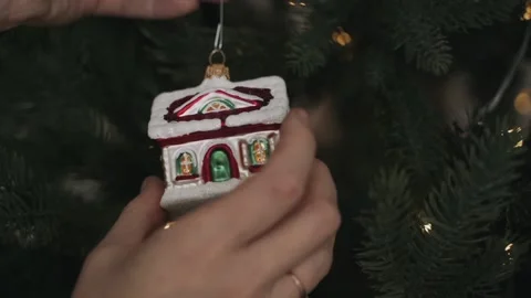 Close-up of woman's hands decorating Christmas tree Stock Footage 164063569