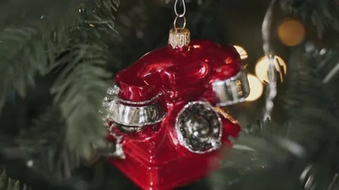 Close-up of woman's hands decorating Christmas tree with telephone toy Stock Footage 165248126