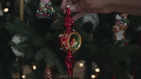 Close-up of woman's hands decorating Christmas tree wist antique retro toy Stock Footage 166545374