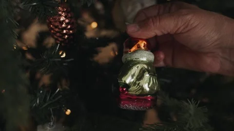 Close-up of woman's hands decorating Christmas tree wist antique retro toy Stock Footage 166545450