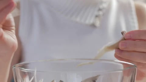 Close-up of a woman's hands dividing fresh mushrooms into fibers and throwing Stock Footage 171073695