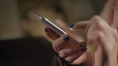 Close-Up, Woman's Hands Flipping Pages on a Smartphone Stock Footage 99379592